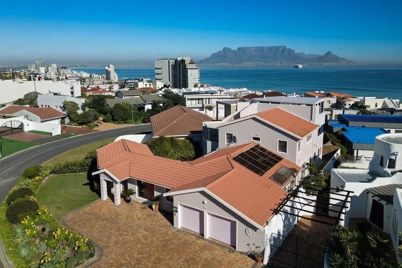 Breathtaking 180-degree ocean views from this remarkable 4 bedroom home in Bloubergstrand.