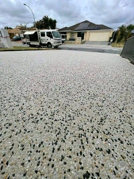Exposed aggregate concrete supply and installation grounds preparation include all necessary