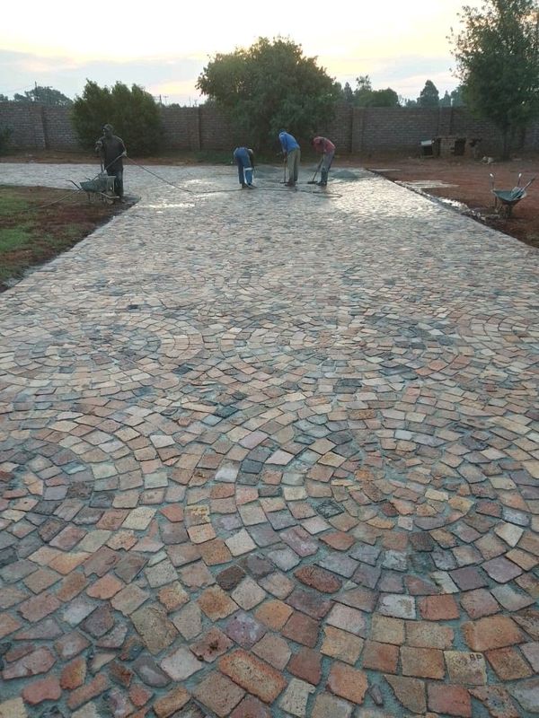 Tar surfacing and brick paving