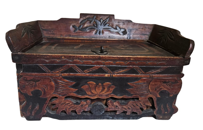 A black lacquered box with painted lotus flower decoration and a lift  top compartment