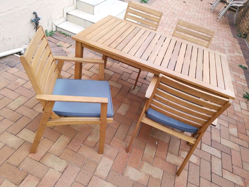 Wooden patio dinning set, 6 seater table and 4 arm chairs with cushions, in good condition. Meranti