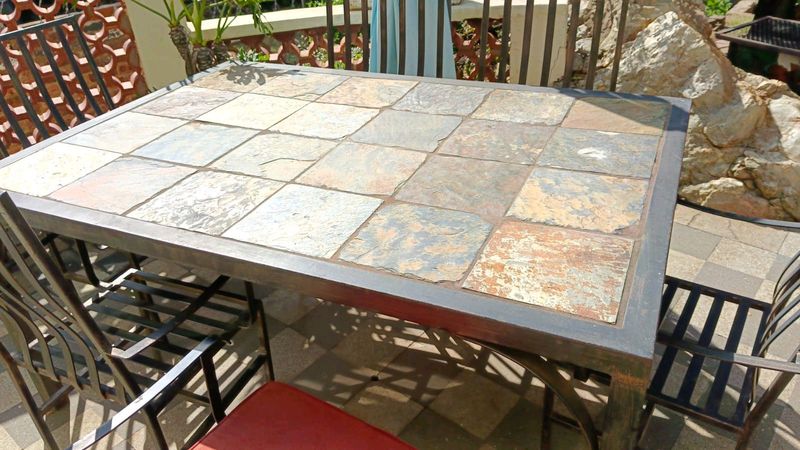 Slasto table top. 6 chairs with cushion.  Outside furniture