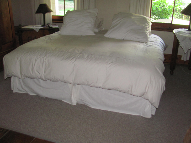 2 Single bed base sets, complete with linen and feather duvets .