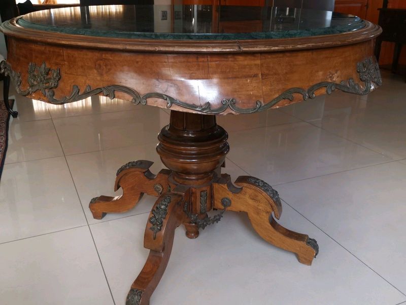 An ornate antique dinning/entrance table. In rare green marble top.