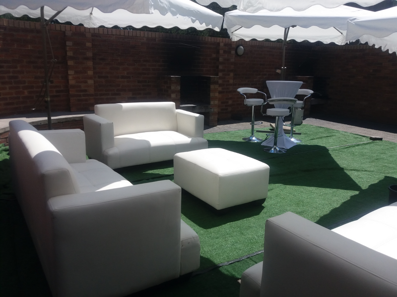 Outdoor furniture hire and decor. Garden umbrellas and white couches decor set up.