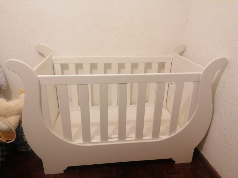 Well loved white Sleigh baby cot