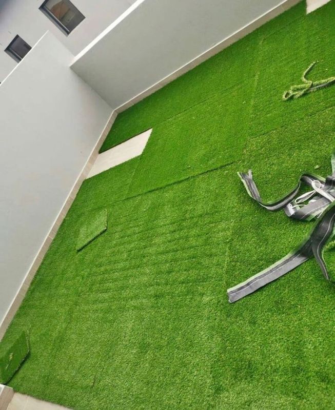 Artificial grass and natural roll on lawn grass