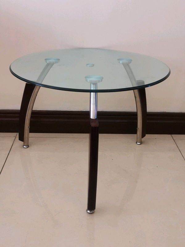 A side table big enough to be a coffee table glass on steel and wooden legs