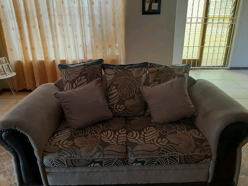 2x 2 seater couch in brown and 1x black glass table