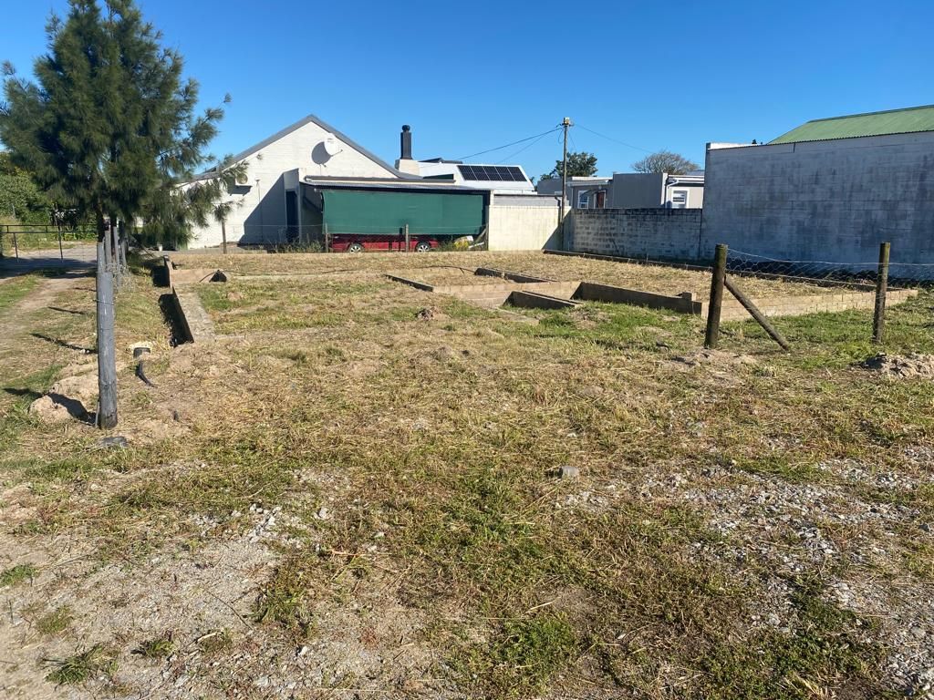 vacant-stand-with-building-plans-and-foundations-for-a-3-bedroom-house