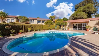 Spacious family home with swimming pool, security, garage and gardens