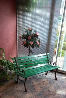 Wooden garden seat bench with cast metal arms/legs