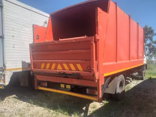 2011 Isuzu FTR700 Garbage box truck with tail lift.