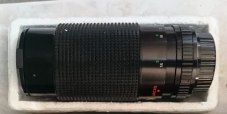 Camera bean bag, vintage lens and 35mm film reel