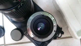 Camera bean bag, vintage lens and 35mm film reel