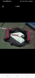 Pull along cricket kit bag with cricket items including set of DP pads and cricket bat