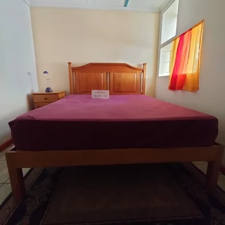 Solid Yellow wood Queen sized Bed and  head board together with 2 side cupboards with drawers.