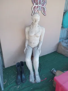 Sculpture of woman sitting on a wooden pedestal stool . Life sized plaster (?) In VGC