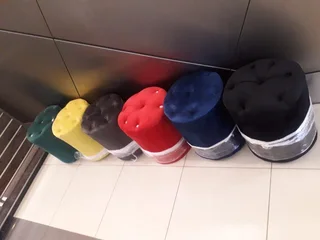 New red velvet ottoman stools with buttons