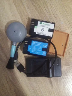 Two LP-E6N batteries for Canon, one charger and a lens brush