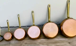 Vintage French copper pans with brass handles.