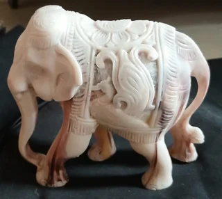Elephant figurine intricately carved with decorative pattern