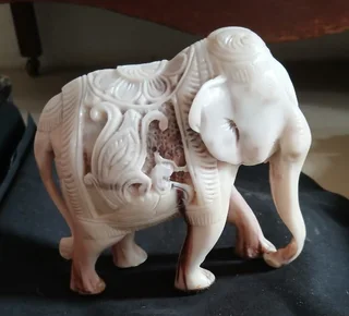 Elephant figurine intricately carved with decorative pattern