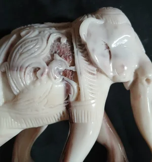 Elephant figurine intricately carved with decorative pattern