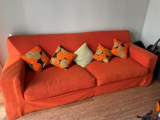 4-seater orange couch with 4 pillows