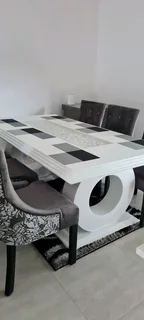 White dining table with six chairs