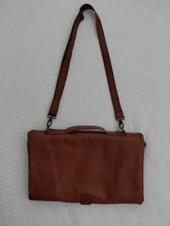 Leather nappies bag and fold out nappy change mat.