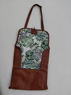 Leather nappies bag and fold out nappy change mat.