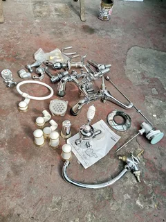 Britannia shower mixer, Victoria style bath taps and various other taps and parts. New