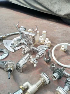 Britannia shower mixer, Victoria style bath taps and various other taps and parts. New