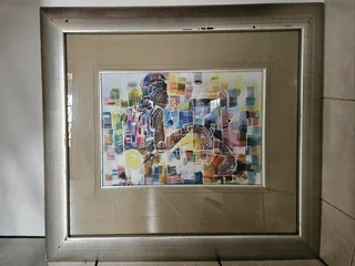Beautiful African art print set in a heavy wooden frame in colored Silver