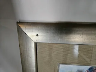 Beautiful African art print set in a heavy wooden frame in colored Silver