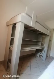 Bunk bed with table and shelves