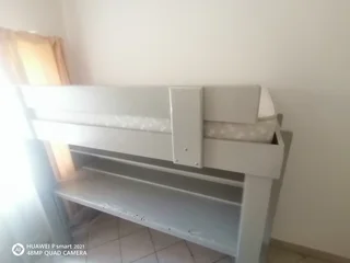 Bunk bed with table and shelves