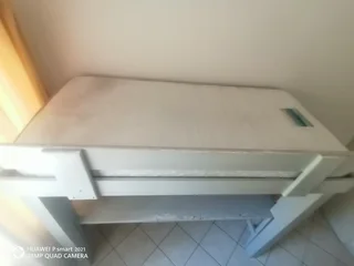 Bunk bed with table and shelves