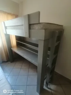 Bunk bed with table and shelves