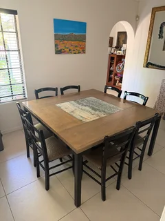 8 seater table with chairs. 1.5m x 1.5m with centre marble piece. In good condition.