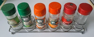 Metal stand for spices. With empty glass bottles.