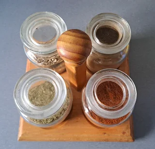 Spices Storage made of Wood . Includes 4 empty glass containers.