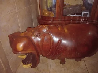 Wooden carved hippo with ivory tusks