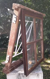 Wooden window with glass panels and built-in burglar bars