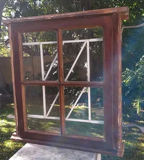 Wooden window with glass panels and built-in burglar bars