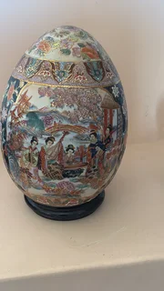 A large hand-painted Japanese Satsuma-style porcelain decorative egg.