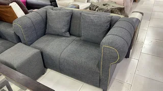 The Home Stores' Two Seater Grey Linen Sofa With Gold Strip Studs On Armrests