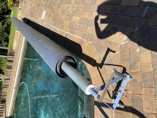 Pool cover with roll up station