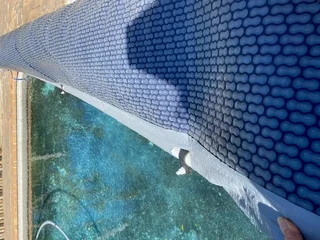 Pool cover with roll up station